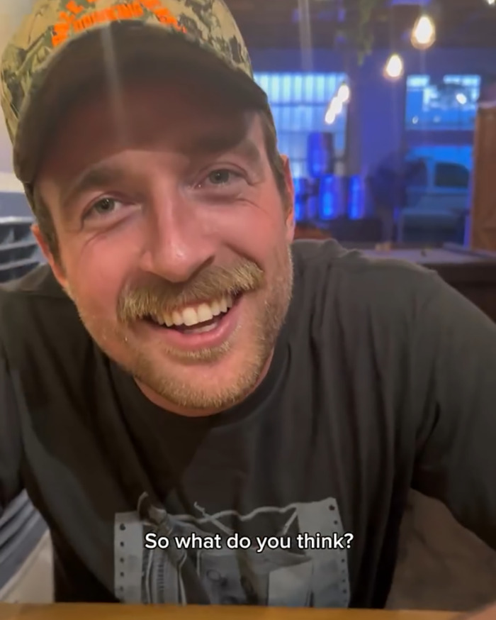 Man with a cap smiling indoors with text caption asking for opinion about psychic drawing and love life changes. Man with a cap smiling indoors with text caption asking for opinion about psychic drawing and love life changes.