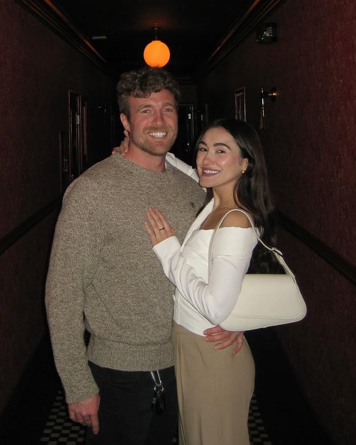 Couple smiling and embracing in dim hallway, celebrating love life changes after psychic drawing went viral. Couple smiling and embracing in dim hallway, celebrating love life changes after psychic drawing went viral.