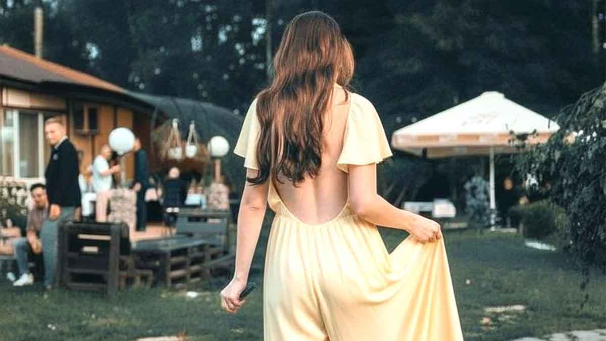 Woman in yellow dress outdoors, highlighting woman exposes brides messages wedding theme in a garden setting.