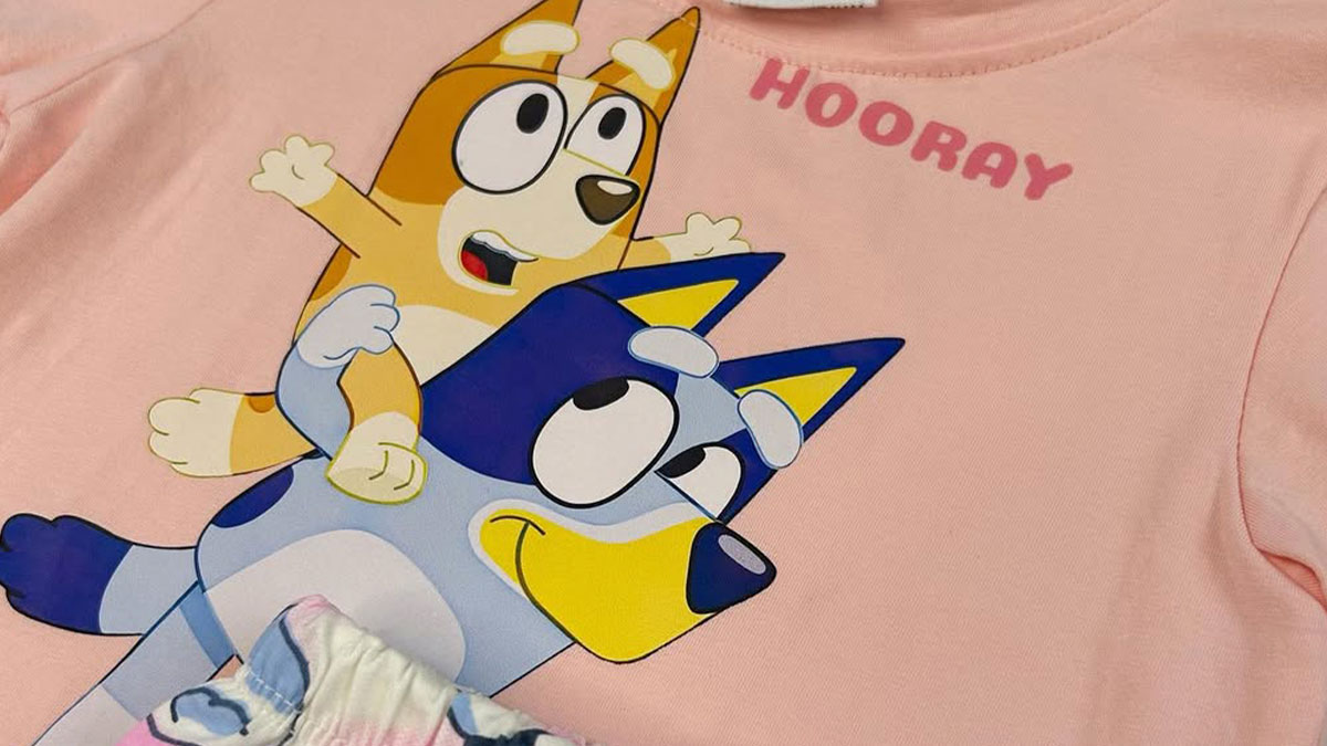 Kids clothing featuring cartoon characters on a pink fabric, hinting at a woman suspecting secret kid at fiancu00e9's place.