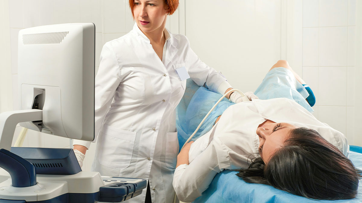 Female doctor performing ultrasound on woman, addressing concerns about pregnancy and tumor diagnosis.