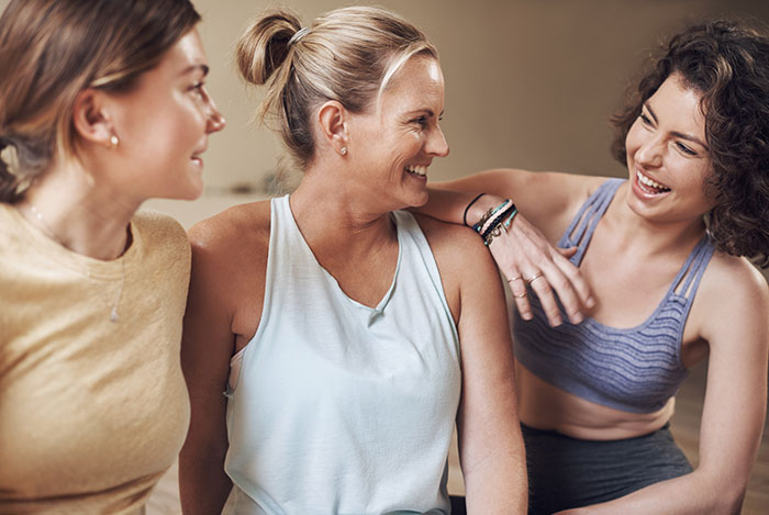 Three women laughing together indoors, capturing a moment related to open marriage and admirer dynamics. Three women laughing together indoors, capturing a moment related to open marriage and admirer dynamics.