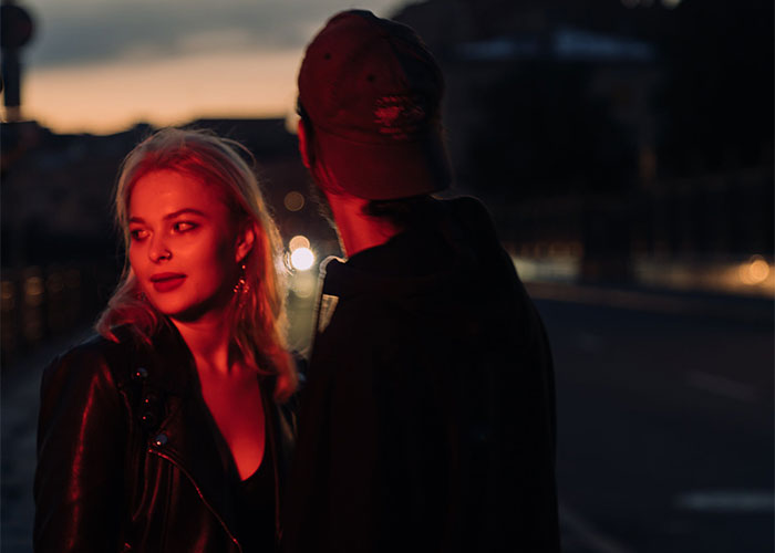 Woman confronts boyfriend’s female friend at night, tense moment related to inappropriate Halloween costume conflict. Woman confronts boyfriend’s female friend at night, tense moment related to inappropriate Halloween costume conflict.