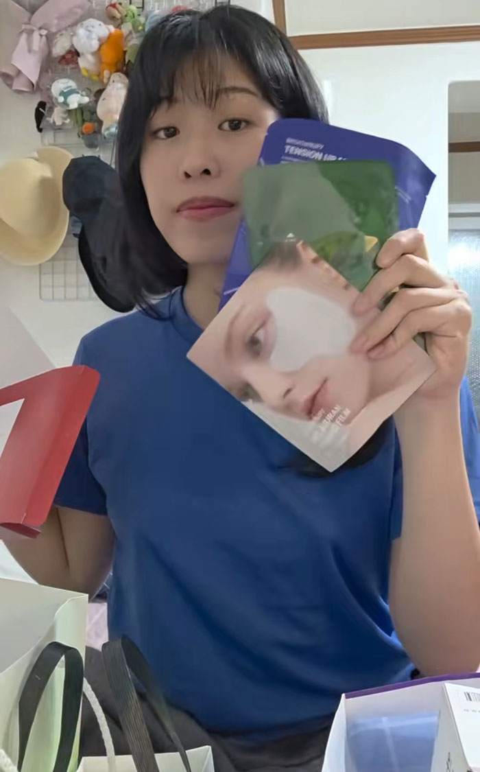 Woman holding skincare gifts received while interviewing for jobs in Korea, showing excitement and product variety indoors. Woman holding skincare gifts received while interviewing for jobs in Korea, showing excitement and product variety indoors.