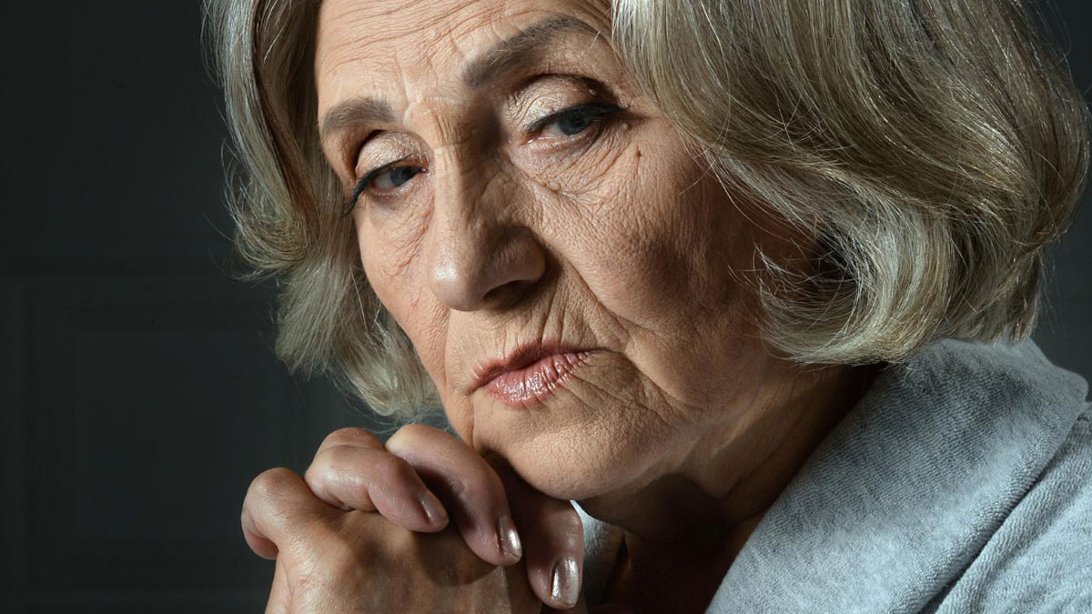 Older woman with a diet-obsessed expression, reflecting on food-shaming and family conflict about eating pie.