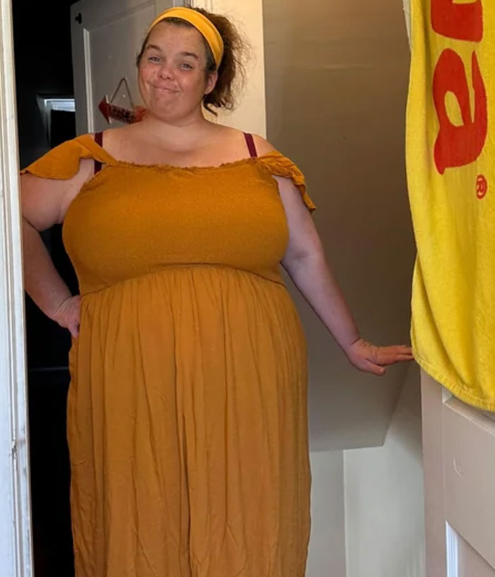 Woman wearing a yellow dress and headband standing in doorway, sharing how Costco helped with weight loss journey. Woman wearing a yellow dress and headband standing in doorway, sharing how Costco helped with weight loss journey.