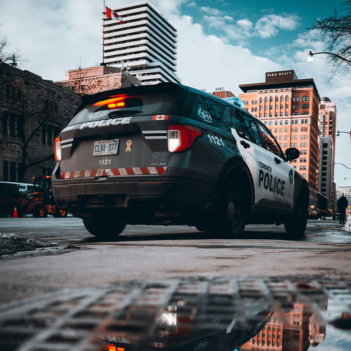 Toronto police car parked on a city street reflecting buildings, related to broken mother fate after slaying young sons news. Toronto police car parked on a city street reflecting buildings, related to broken mother fate after slaying young sons news.