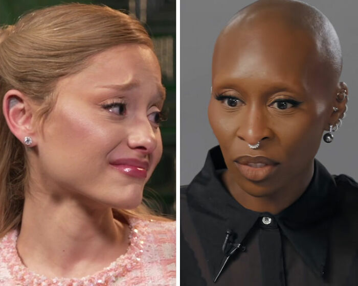 Ariana Grande and Cynthia Erivo shown in separate interview settings, reacting with serious expressions. Ariana Grande and Cynthia Erivo shown in separate interview settings, reacting with serious expressions.