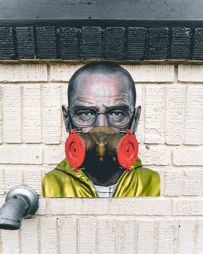 Paper cutout of a man wearing glasses and a gas mask, perfectly integrated with real life on a brick wall. Paper cutout of a man wearing glasses and a gas mask, perfectly integrated with real life on a brick wall.