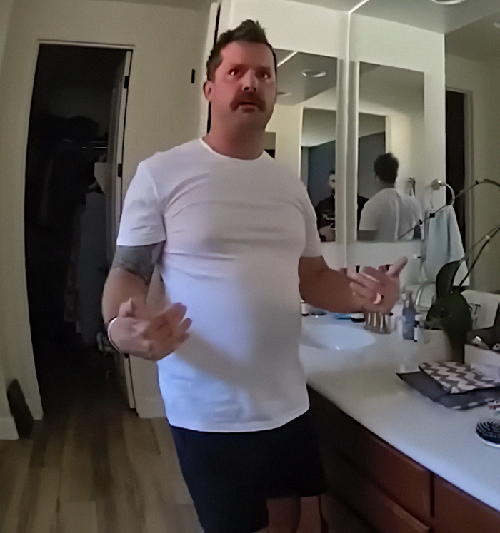 Man in a white shirt discussing chilling details after dad left 2YO in car during adult video binge found deceased. Man in a white shirt discussing chilling details after dad left 2YO in car during adult video binge found deceased.