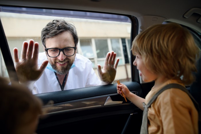 Man prioritizes work, pretending not to have a family, while interacting with child through car window.