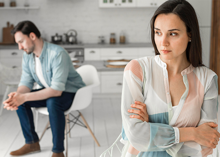 Couple in a tense kitchen scene, with man treating wife like his servant and woman looking upset and distant. Couple in a tense kitchen scene, with man treating wife like his servant and woman looking upset and distant.