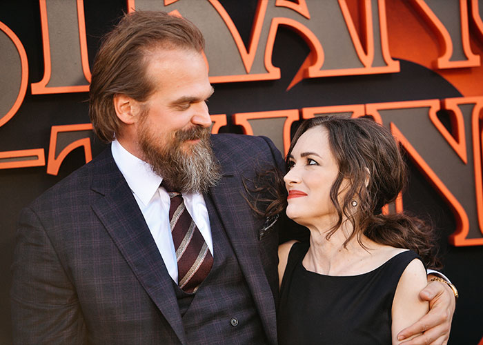 David Harbour and Stranger Things co-star sharing a warm moment at a red carpet event promoting the show. David Harbour and Stranger Things co-star sharing a warm moment at a red carpet event promoting the show.