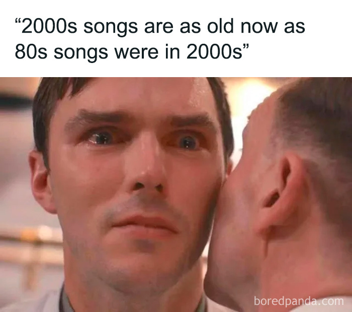 Man with surprised expression listening to a whisper, illustrating funny memes that make life feel lighter.