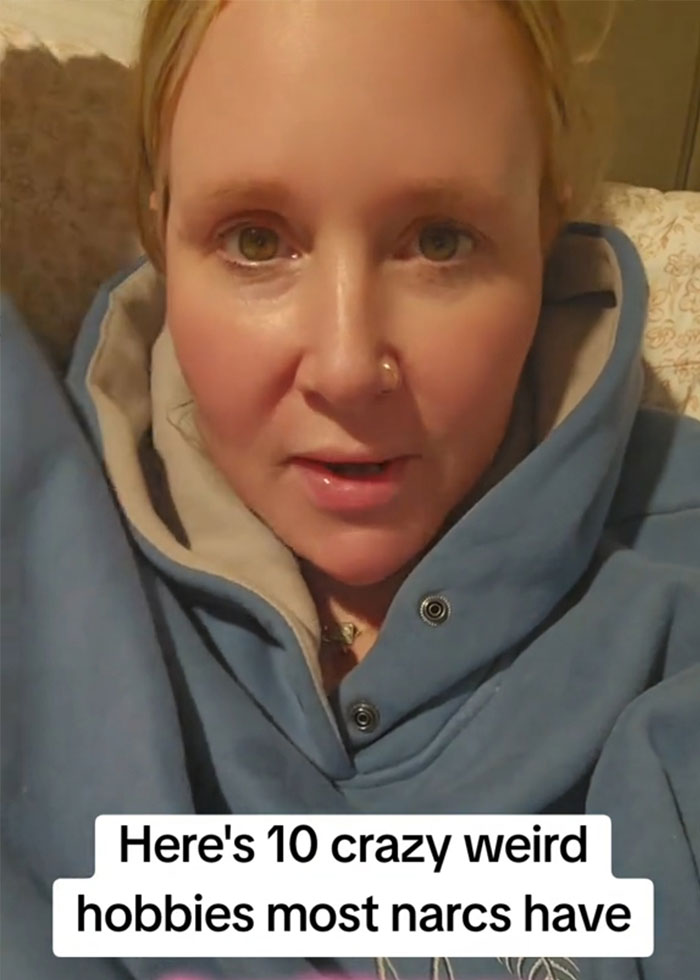 Woman wearing a blue hoodie discussing red flags that could mean someone is a narcissist in a casual setting.