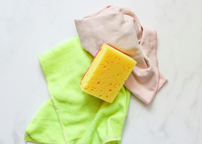 Yellow cleaning sponge with green and pink cloths representing horrible gifts people have actually received.
