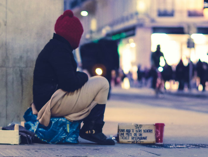 Person sitting on a city sidewalk at night, illustrating the theme of wildest family drama shared online.