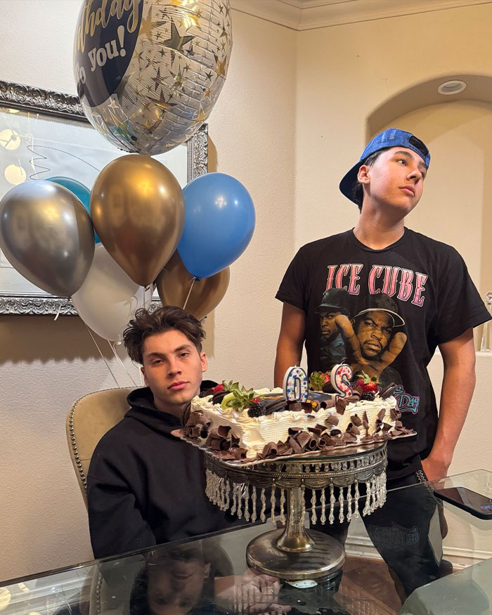 Two young men celebrating with a birthday cake and balloons, unrelated to fake plastic surgeon or silicone injections news. Two young men celebrating with a birthday cake and balloons, unrelated to fake plastic surgeon or silicone injections news.