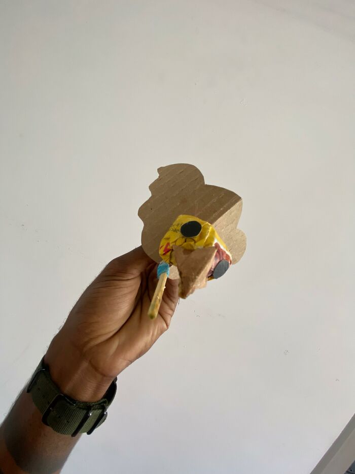 Hand holding a handmade cardboard mini bird used as a bird mom for rescuing a great kiskadee. Hand holding a handmade cardboard mini bird used as a bird mom for rescuing a great kiskadee.