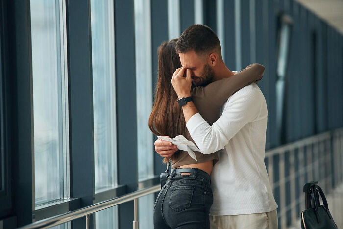 Man and woman embracing with emotional expressions, illustrating signs a child was never loved properly.