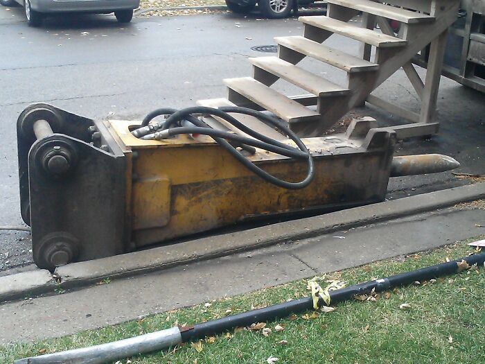 Heavy hydraulic construction equipment lying on the ground, illustrating origins of common word etymology.