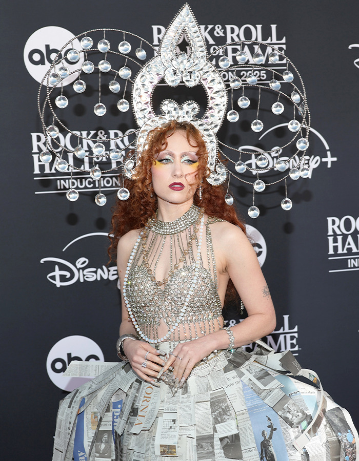 Chappell Roan wearing an avant-garde jeweled headdress and newspaper-inspired dress at the Rock Hall of Fame 2025.