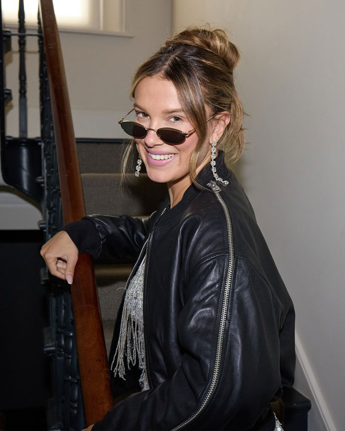 Millie Bobby Brown smiling in sunglasses and leather jacket, fans furious over legally changing her name news. Millie Bobby Brown smiling in sunglasses and leather jacket, fans furious over legally changing her name news.