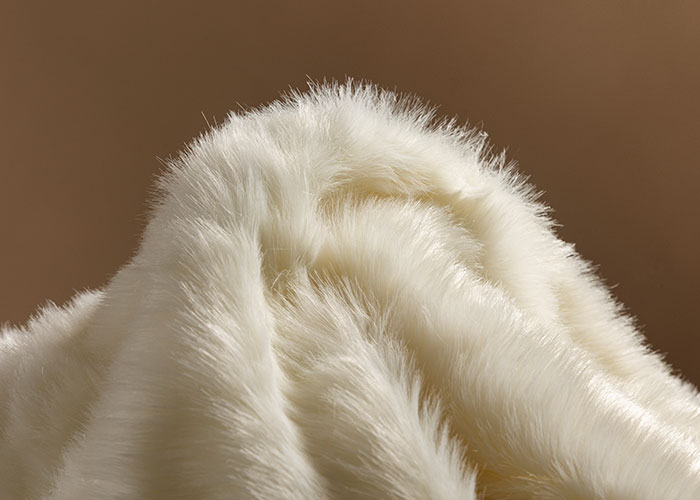 Close-up of soft white fur texture, illustrating genius cleaning hacks inspired by laziness for easy fabric care.
