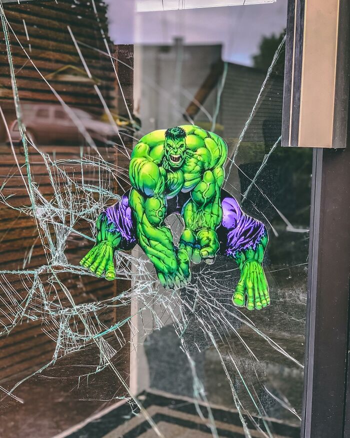 Green superhero paper cutout interacting with c*****d glass, showcasing brilliant paper cutouts by Rudy Willingham in real life. Green superhero paper cutout interacting with c*****d glass, showcasing brilliant paper cutouts by Rudy Willingham in real life.