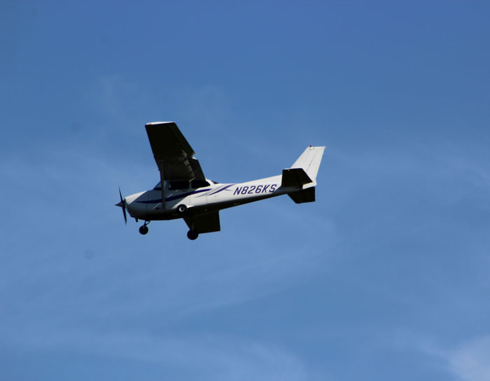 Small single-engine plane flying in clear sky, illustrating pilots' terrifying close calls mid-flight experiences.