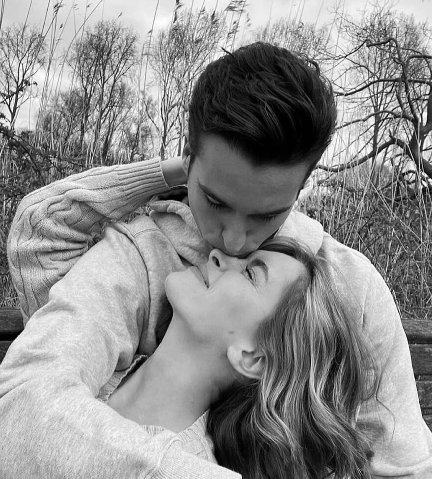 A couple sharing a tender kiss outdoors, illustrating different types of kisses and their cultural significance.