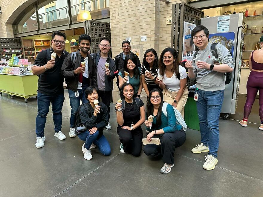Group of diverse young adults enjoying ice cream together, promoting unity and breaking Asian stereotypes in a modern world.