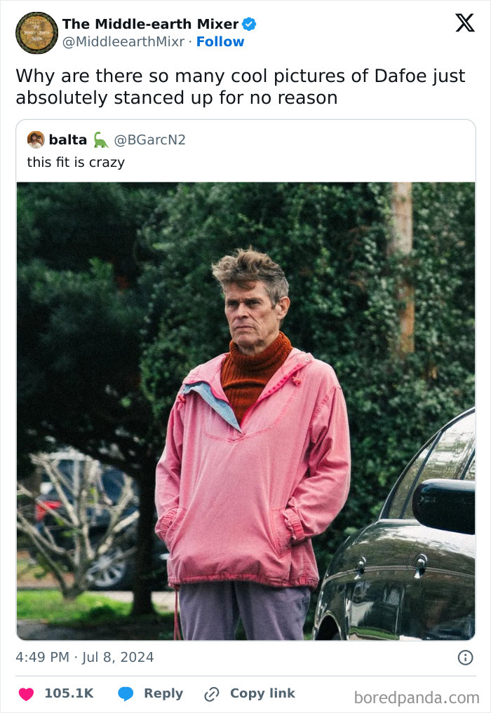 Man wearing a pink jacket and red turtleneck standing outside, an example of pics that go hard street fashion style.