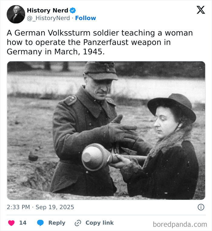 A German Volkssturm soldier teaching a woman to operate a Panzerfaust weapon during World War II history.