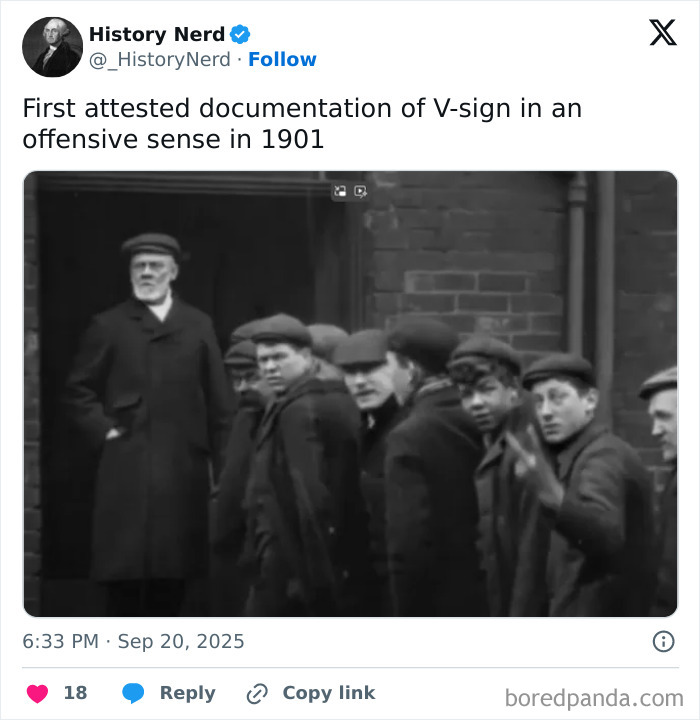 Black and white historical photo from 1901 showing a group of men, one making an offensive V-sign gesture.