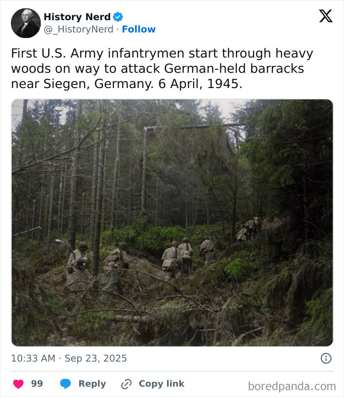 U.S. Army infantrymen moving through heavy woods during World War II in a rare and powerful history photo.