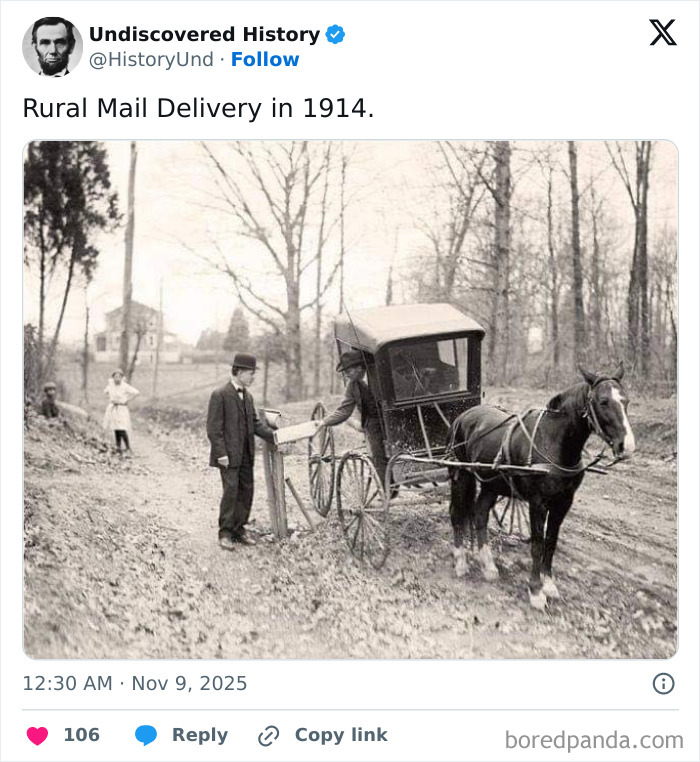 Rural mail delivery in 1914 showing a horse-drawn carriage and a man receiving mail on a dirt road in a wooded area.