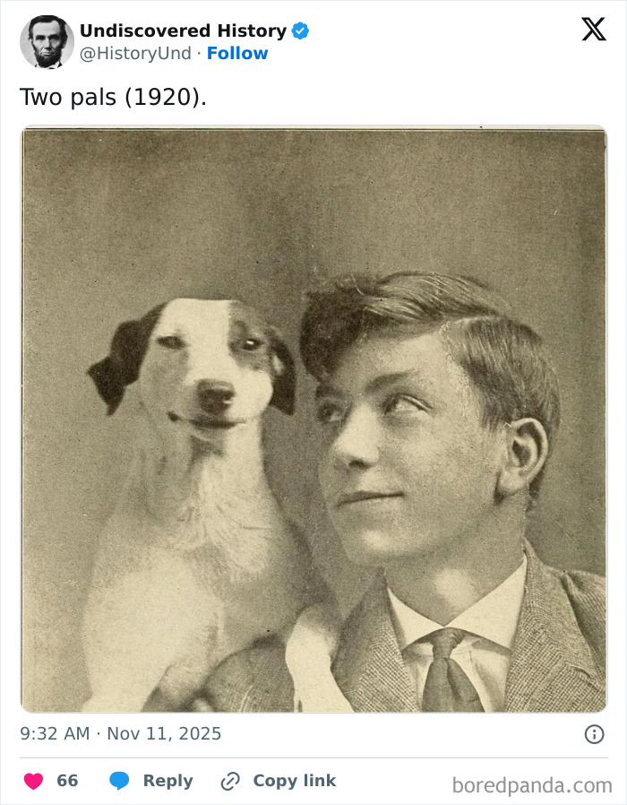 Vintage photo of a young man and his dog, capturing a fascinating moment lost to time from 1920.