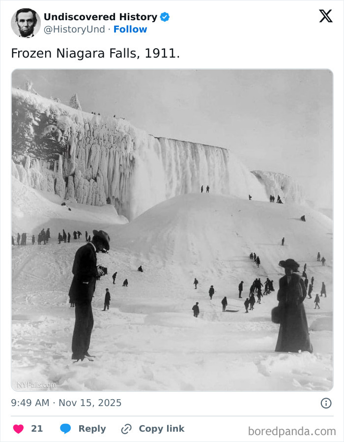 Frozen Niagara Falls in 1911, captured in a fascinating photo revealing a moment lost to time with people exploring the icy landscape.