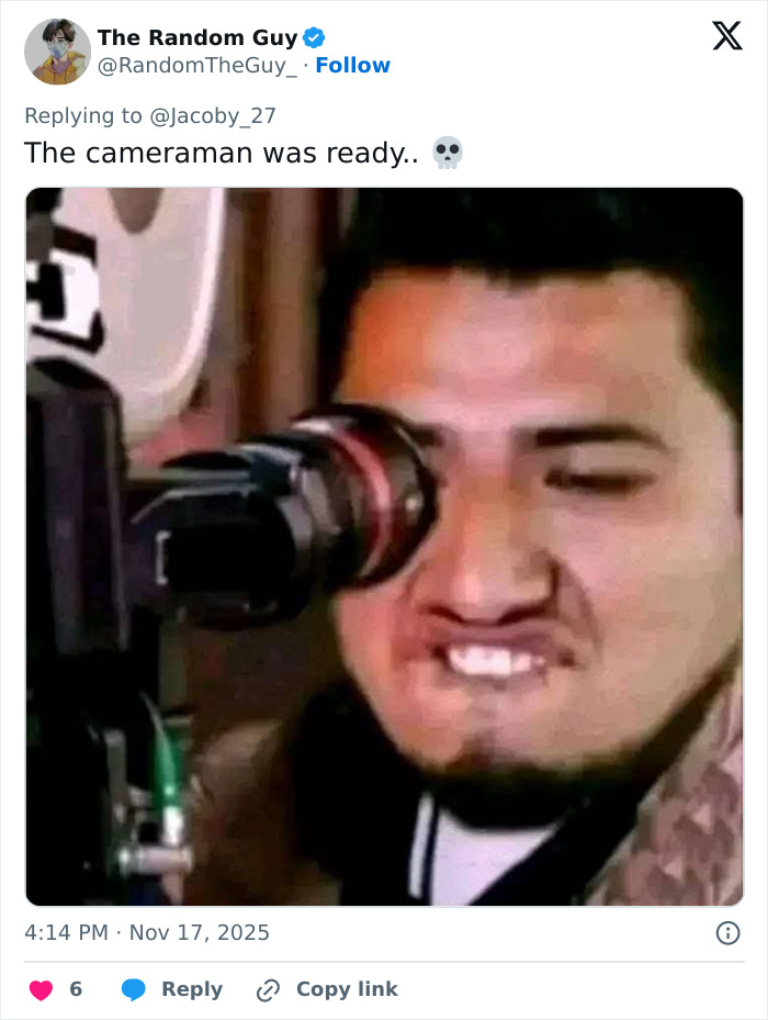 Man making a focused face while looking through a camera lens capturing the stunning woman at Georgia-Texas game