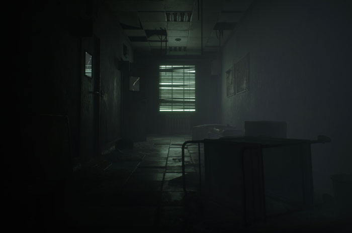Dark abandoned hallway with broken ceiling panels and scattered furniture, capturing a creepy urban explorer moment.
