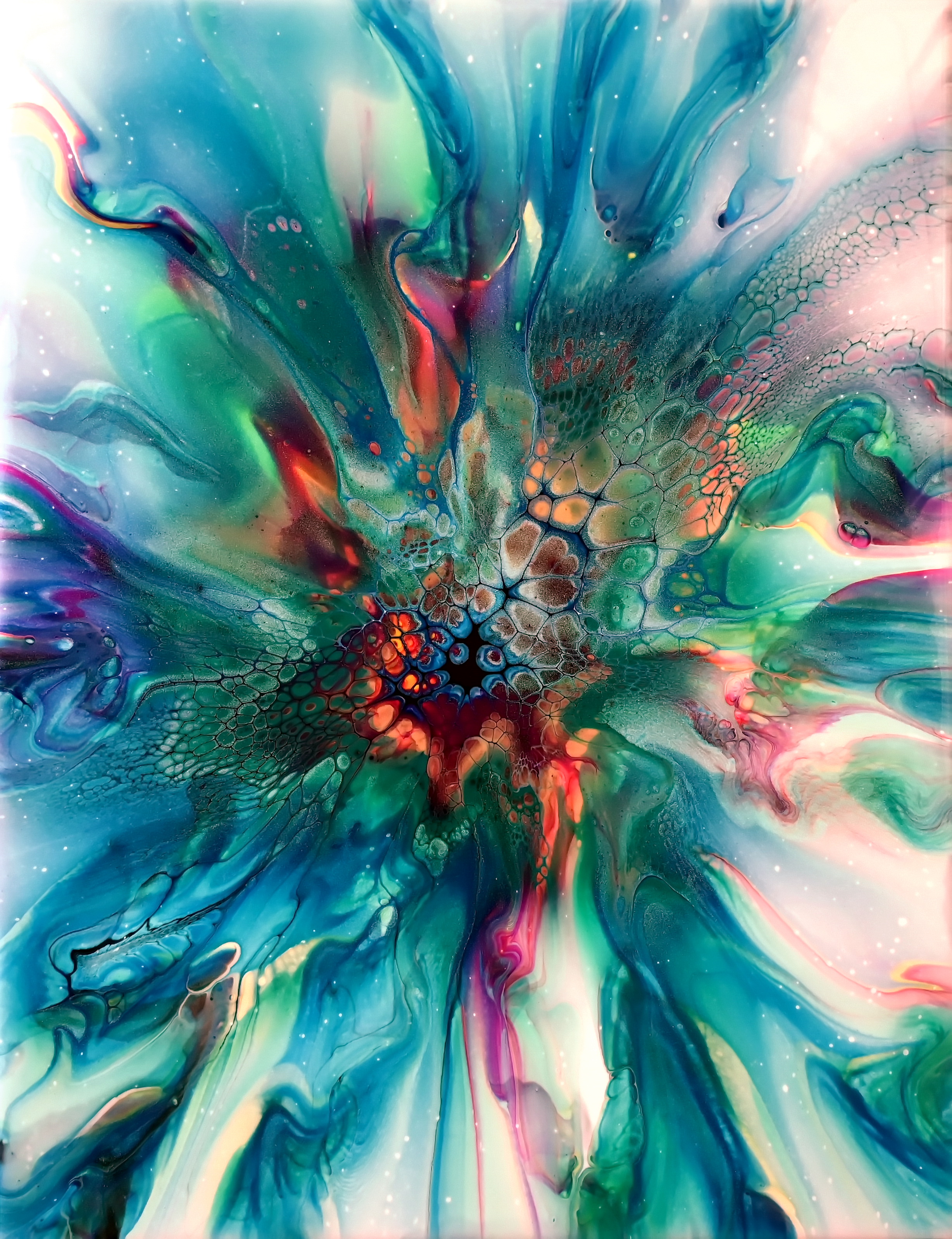 Abstract acrylic pouring bloom art with vibrant blue, green, and red colors blending and creating detailed cell patterns.