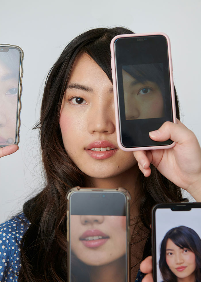 Young woman surrounded by multiple phone screens showing parts of her face, illustrating narcissist red flags. Young woman surrounded by multiple phone screens showing parts of her face, illustrating narcissist red flags.