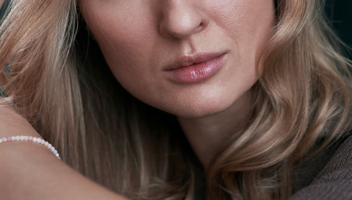 Close-up of a woman with blonde hair and neutral expression, reflecting on wild family drama shared online.