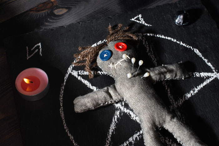 Creepy skull beside a melting candle on a dark surface, evoking terrifying moments in urban exploration.