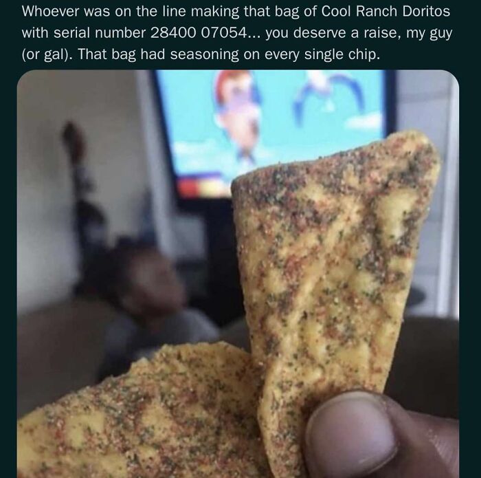 Close-up of a Cool Ranch Doritos chip covered with seasoning, featured in randomly funny memes that lighten life.