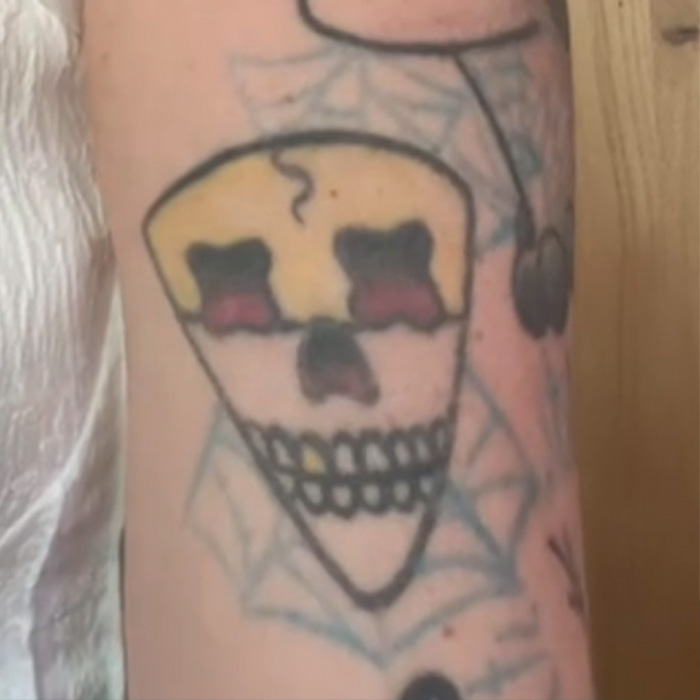 Tattoo artist's skull tattoo with spider web, illustrating viral tattoo regrets and challenges faced after Miley design. Tattoo artist's skull tattoo with spider web, illustrating viral tattoo regrets and challenges faced after Miley design.