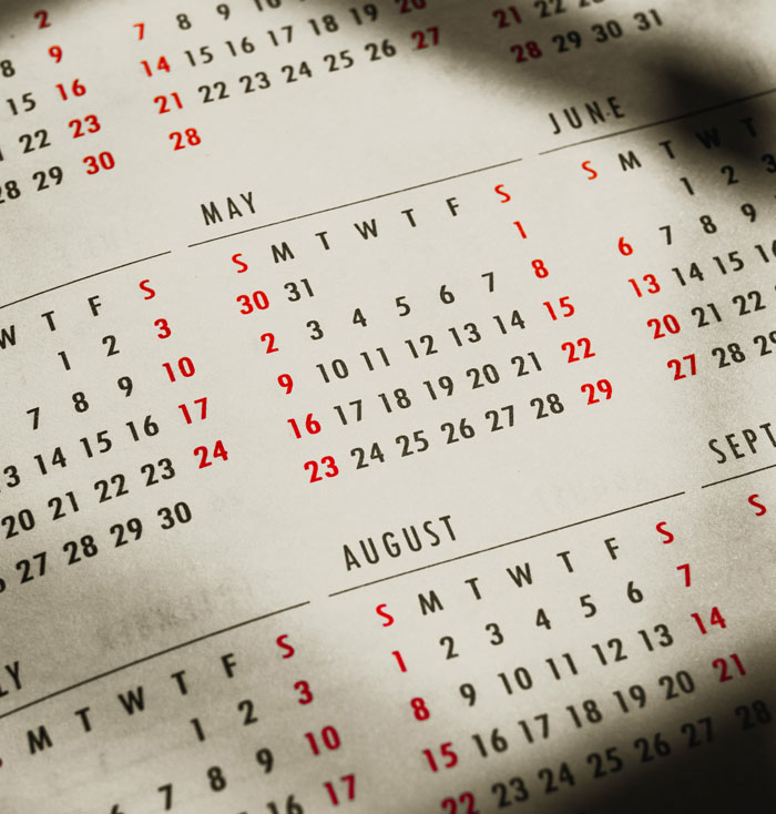 Close-up of a calendar showing months and dates, symbolizing timelines in wild family drama stories shared online.