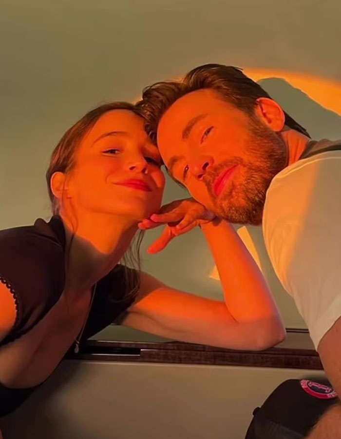 Chris Evans and partner posing closely with warm sunlight, amid viral cheating rumors and scandalous blind items.