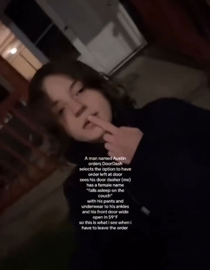 Person outdoors at night making a rude gesture, illustrating DoorDash driver arrested after recording undressed customer video.